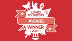Red badge with white illustrations and text that reads "Loved by Guests Award Winner 2021.